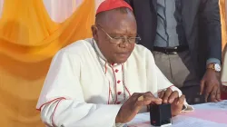 Le Cardinal Fridolin Ambongo signant le décret de création de l'Université Catholique Omnia dans l'archidiocèse de Kinshasa en RD Congo. / 