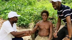 Le Père Innocent Akum Wefon (à genoux) échange des civilités avec le chef des Pygmées de Kribi au Cameroun. Crédit : P. Innocent Akum Wefon / 